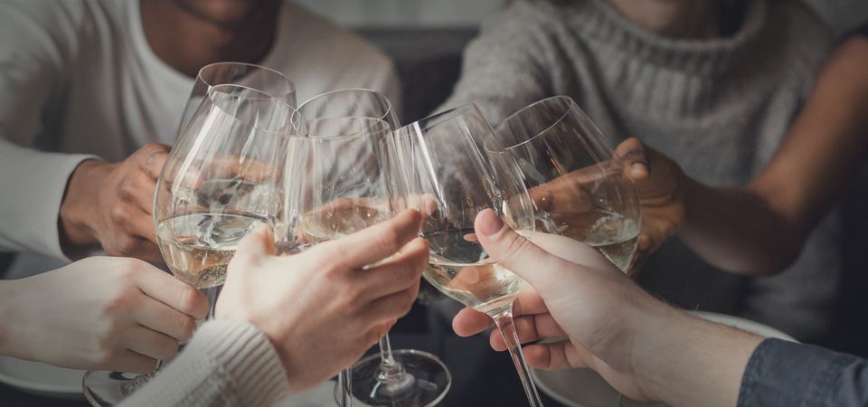 wine tasters cheers at table