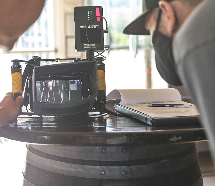 Pour team members reviewing winery video shots on camera