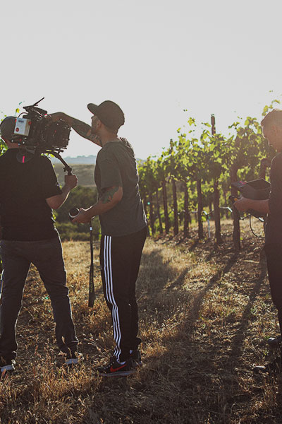 pour team at vineyard recording video