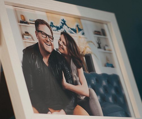 A framed photo of a man and a woman smiling.
