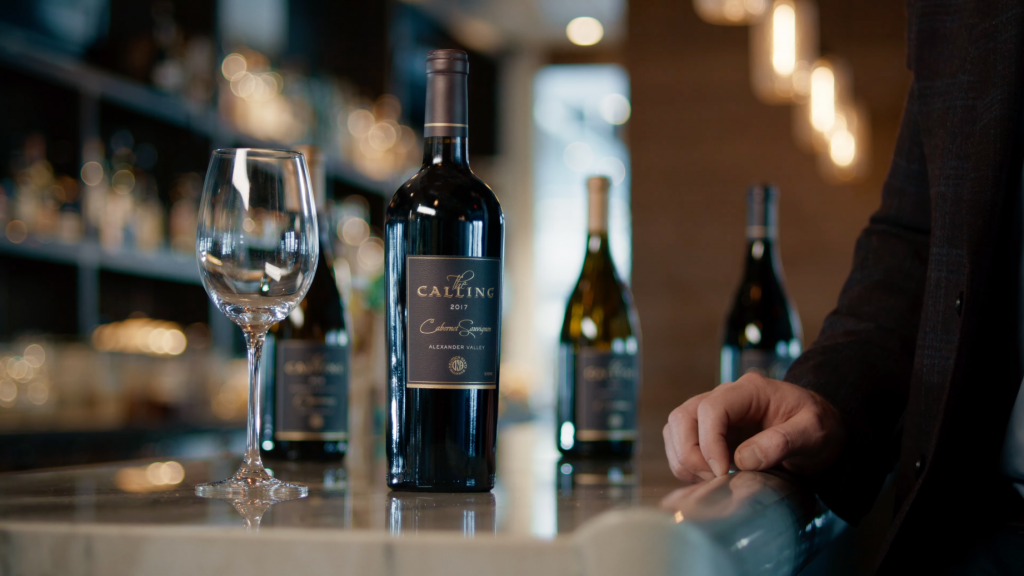 The Calling Wine Still 13 A wine bottle with the label 'The Calling' next to an empty wine glass.