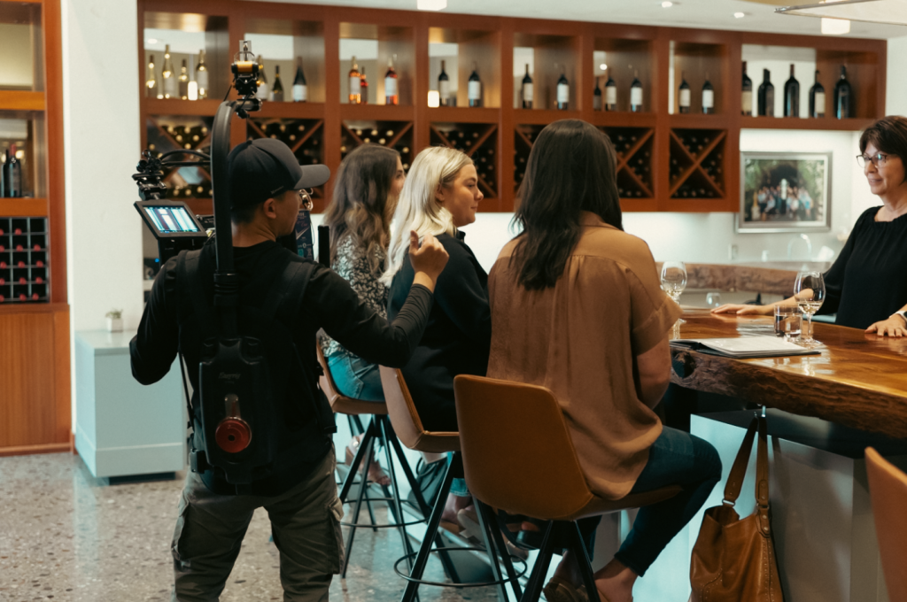 Behind the Scenes LangeTwins II A videographer filming on a set for LangeTwins.